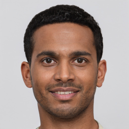 Joyful latino young-adult male with short  black hair and brown eyes