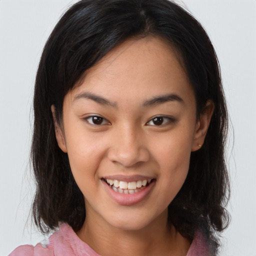 Joyful latino young-adult female with medium  brown hair and brown eyes