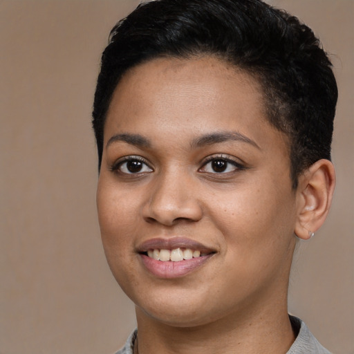Joyful latino young-adult female with short  black hair and brown eyes