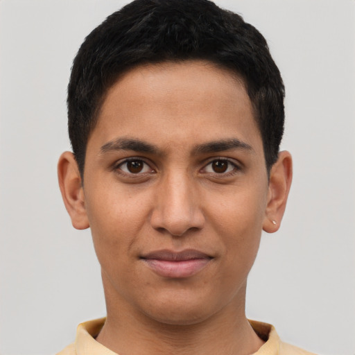 Joyful latino young-adult male with short  brown hair and brown eyes