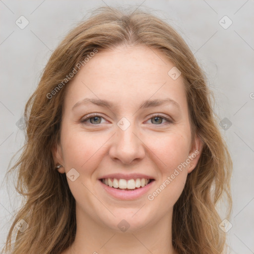 Joyful white young-adult female with long  brown hair and green eyes