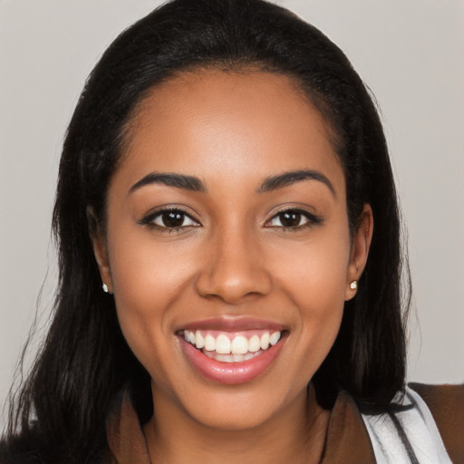 Joyful latino young-adult female with long  black hair and brown eyes