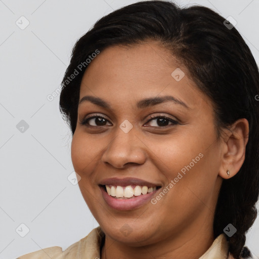 Joyful latino young-adult female with long  brown hair and brown eyes