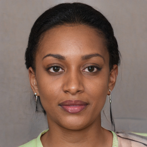 Joyful black young-adult female with short  brown hair and brown eyes