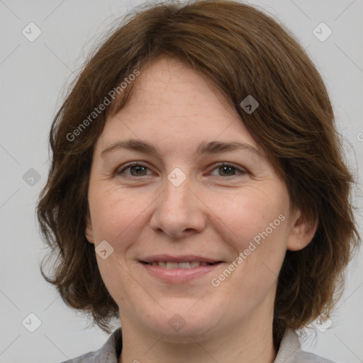 Joyful white adult female with medium  brown hair and grey eyes