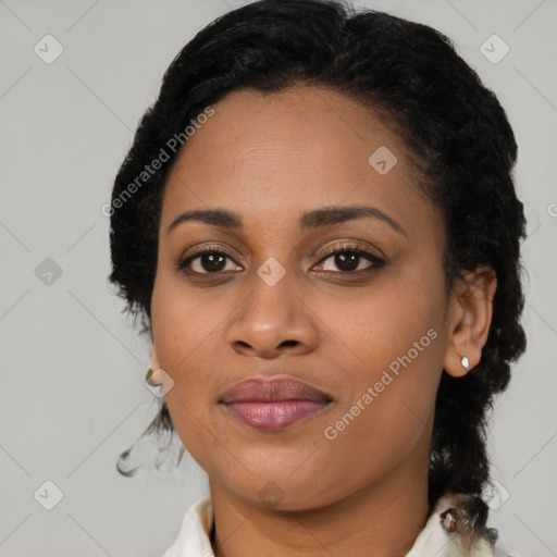 Joyful black young-adult female with short  black hair and brown eyes
