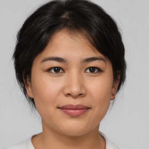 Joyful asian young-adult female with medium  brown hair and brown eyes