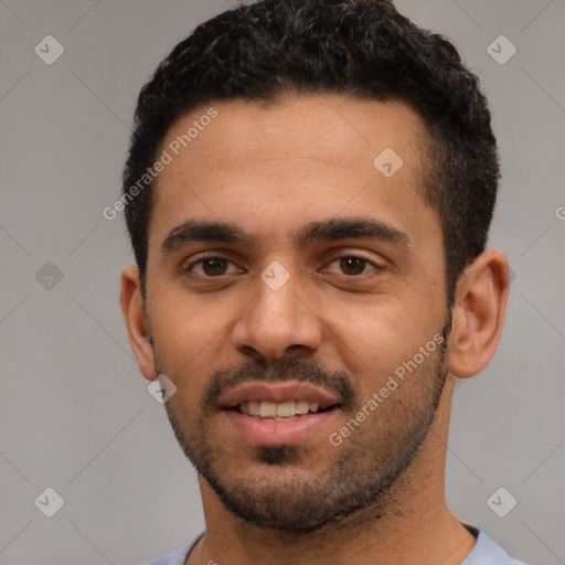 Joyful white young-adult male with short  black hair and brown eyes