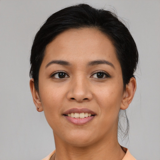 Joyful asian young-adult female with short  black hair and brown eyes