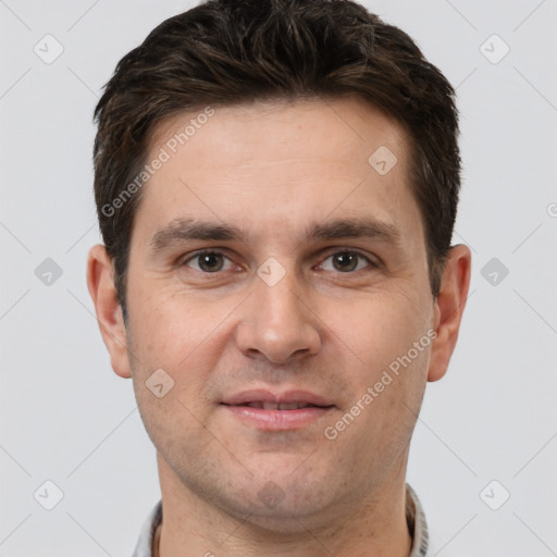 Joyful white adult male with short  brown hair and brown eyes