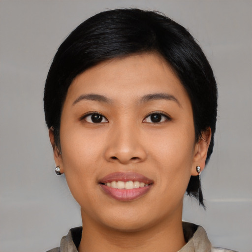 Joyful asian young-adult female with medium  black hair and brown eyes