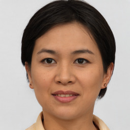 Joyful asian young-adult female with short  brown hair and brown eyes