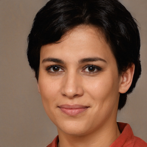 Joyful white young-adult female with medium  brown hair and brown eyes