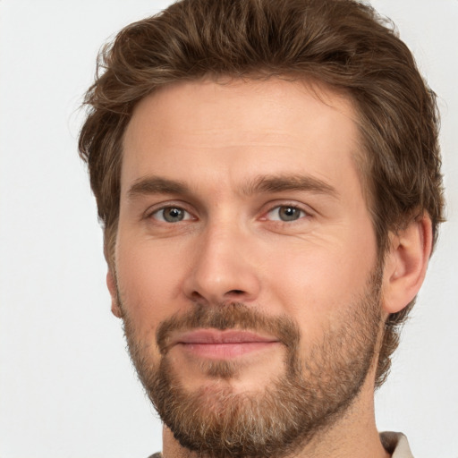 Joyful white adult male with short  brown hair and brown eyes