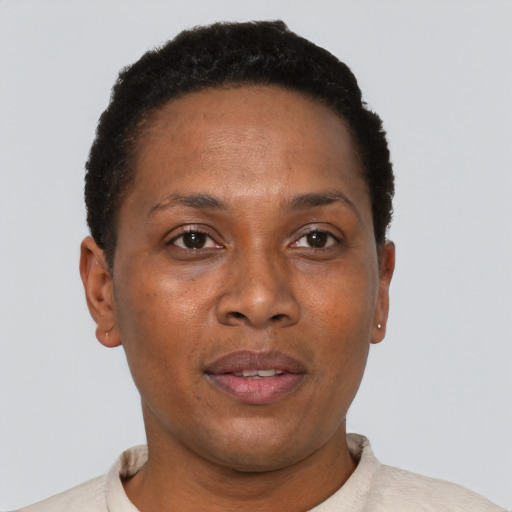 Joyful black young-adult female with short  black hair and brown eyes