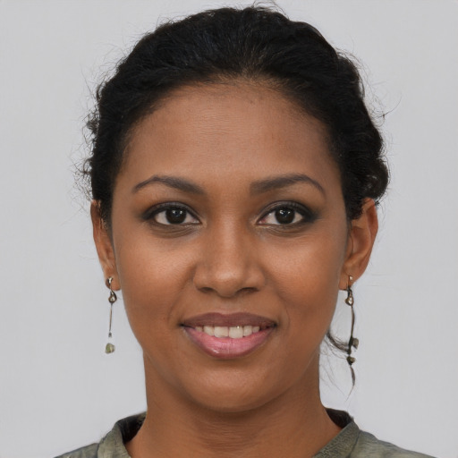 Joyful black young-adult female with short  brown hair and brown eyes
