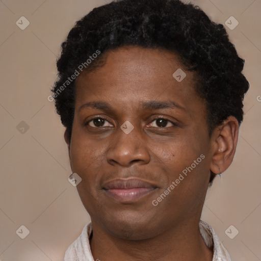 Joyful black young-adult male with short  brown hair and brown eyes