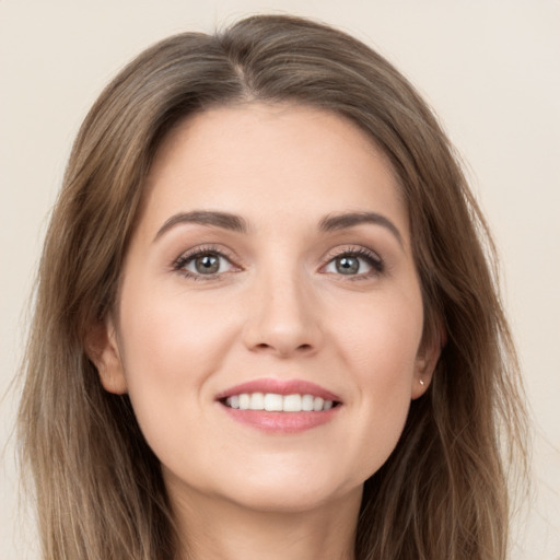 Joyful white young-adult female with long  brown hair and grey eyes