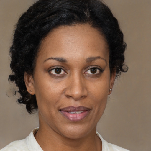 Joyful black adult female with short  brown hair and brown eyes