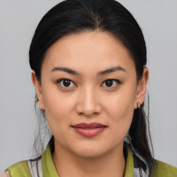 Joyful asian young-adult female with medium  black hair and brown eyes