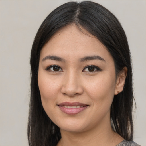 Joyful latino young-adult female with medium  brown hair and brown eyes