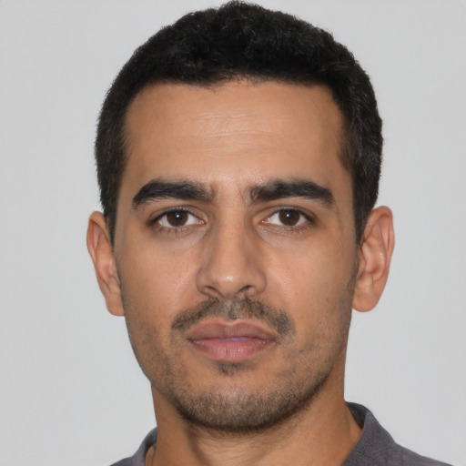 Neutral latino young-adult male with short  black hair and brown eyes