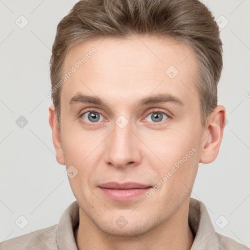 Joyful white young-adult male with short  brown hair and grey eyes