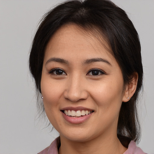 Joyful asian young-adult female with medium  brown hair and brown eyes