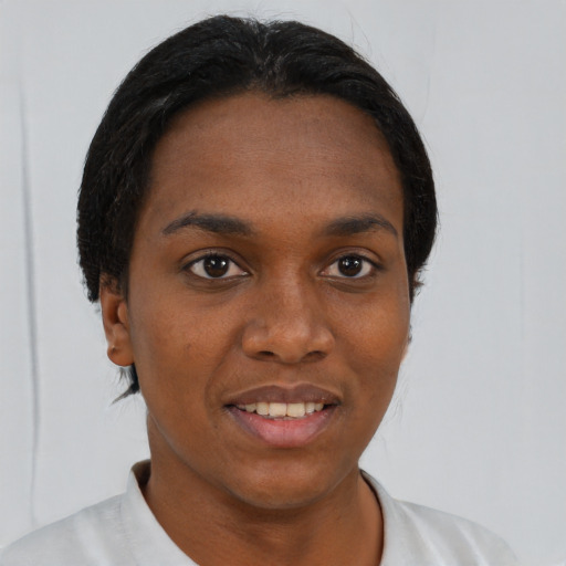 Joyful black young-adult female with short  black hair and brown eyes