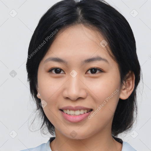 Joyful asian young-adult female with medium  black hair and brown eyes