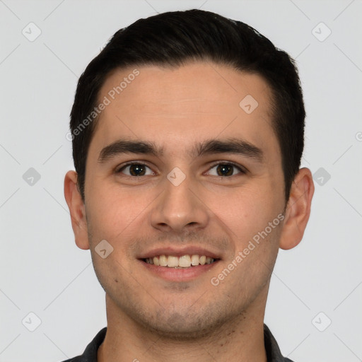 Joyful white young-adult male with short  black hair and brown eyes