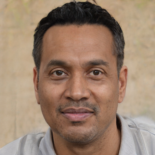 Joyful asian adult male with short  black hair and brown eyes