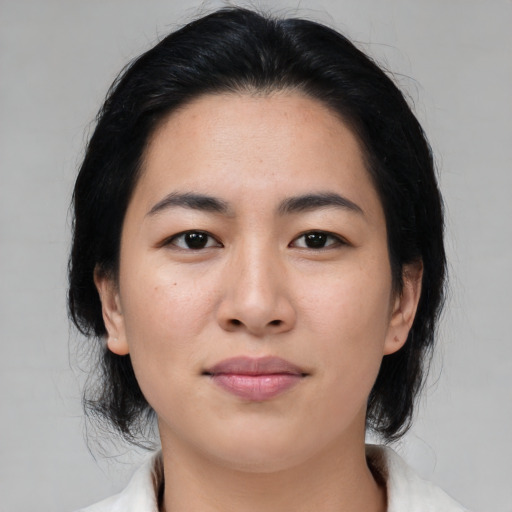 Joyful asian young-adult female with medium  black hair and brown eyes