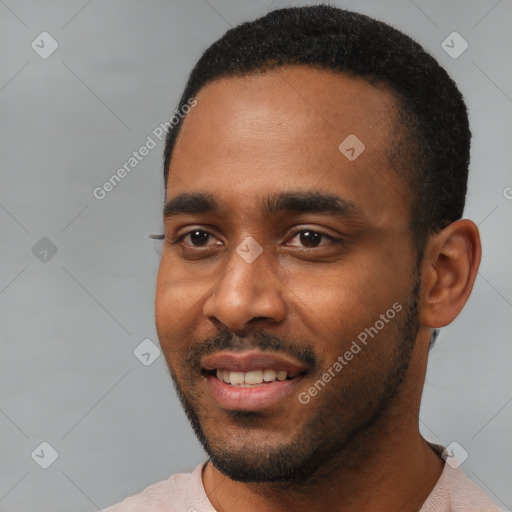 Joyful black young-adult male with short  black hair and brown eyes