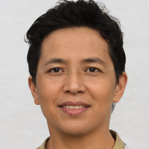 Joyful asian adult male with short  brown hair and brown eyes