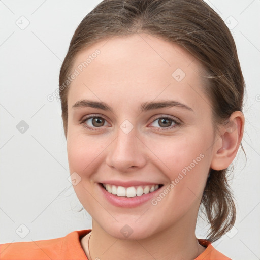 Joyful white young-adult female with medium  brown hair and grey eyes