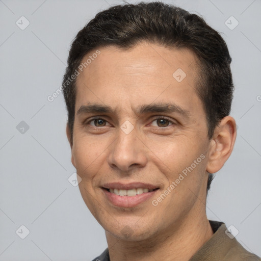 Joyful white adult male with short  brown hair and brown eyes