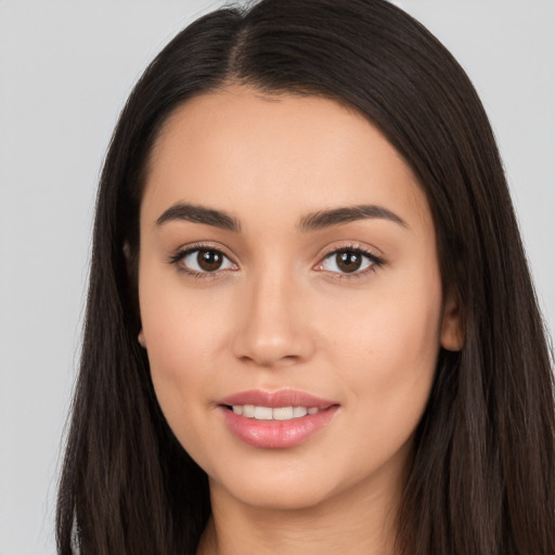 Joyful white young-adult female with long  black hair and brown eyes