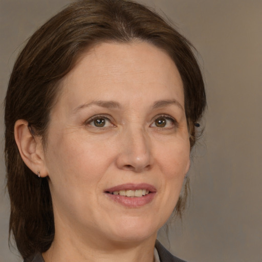 Joyful white adult female with medium  brown hair and brown eyes