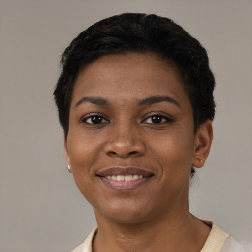 Joyful black young-adult female with short  black hair and brown eyes