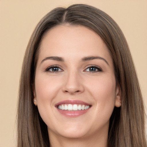 Joyful white young-adult female with long  brown hair and brown eyes