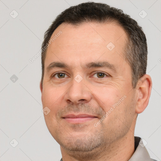 Joyful white adult male with short  brown hair and brown eyes