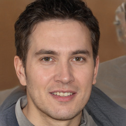 Joyful white adult male with short  brown hair and brown eyes