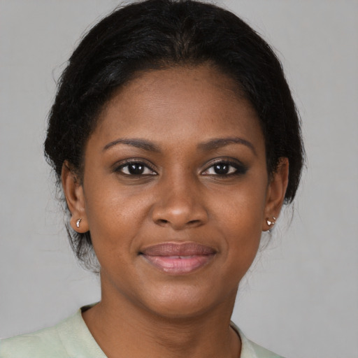 Joyful black young-adult female with medium  brown hair and brown eyes