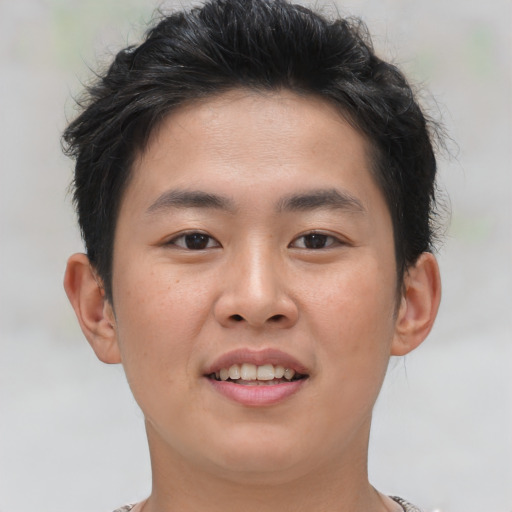 Joyful asian young-adult male with short  brown hair and brown eyes