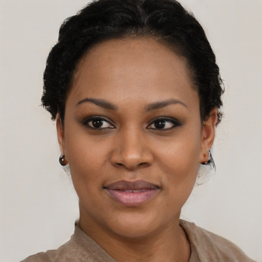 Joyful black young-adult female with short  brown hair and brown eyes