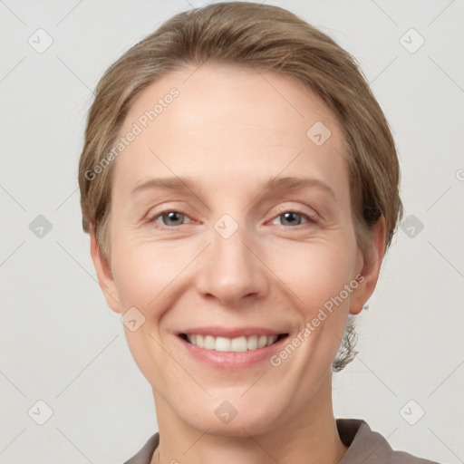 Joyful white adult female with short  brown hair and grey eyes