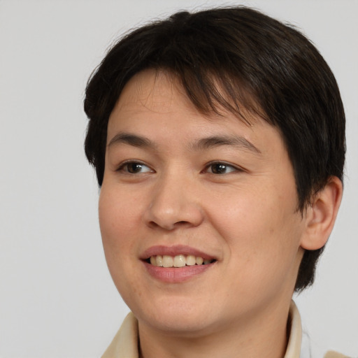 Joyful asian young-adult female with short  brown hair and brown eyes