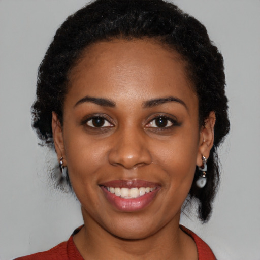 Joyful latino young-adult female with medium  black hair and brown eyes