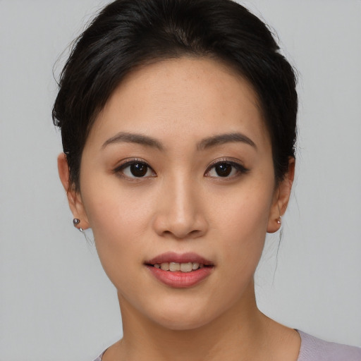 Joyful asian young-adult female with short  brown hair and brown eyes